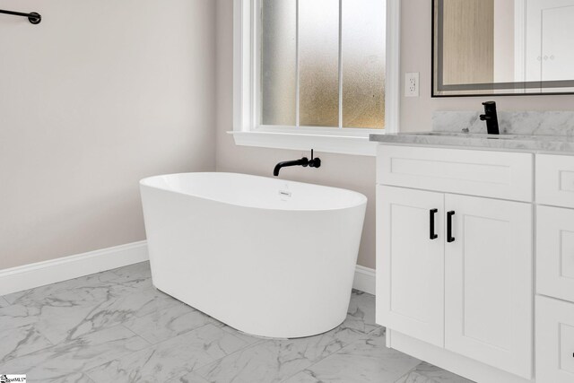 bathroom with vanity and a bath