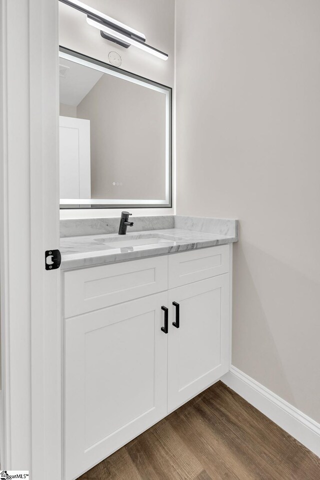 bathroom with vanity and wood-type flooring