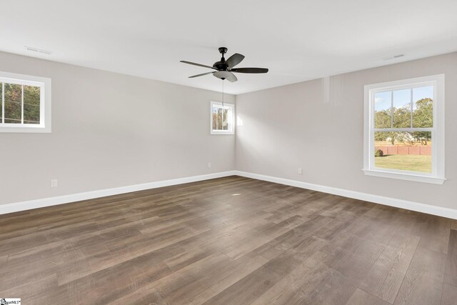 unfurnished room featuring dark hardwood / wood-style floors and ceiling fan