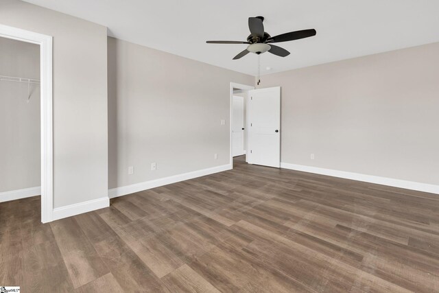 unfurnished bedroom featuring dark wood-type flooring, a closet, and ceiling fan