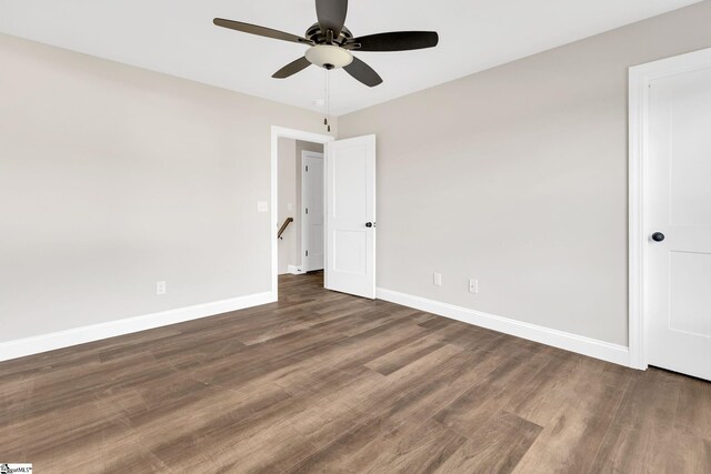 unfurnished room with ceiling fan and dark hardwood / wood-style floors