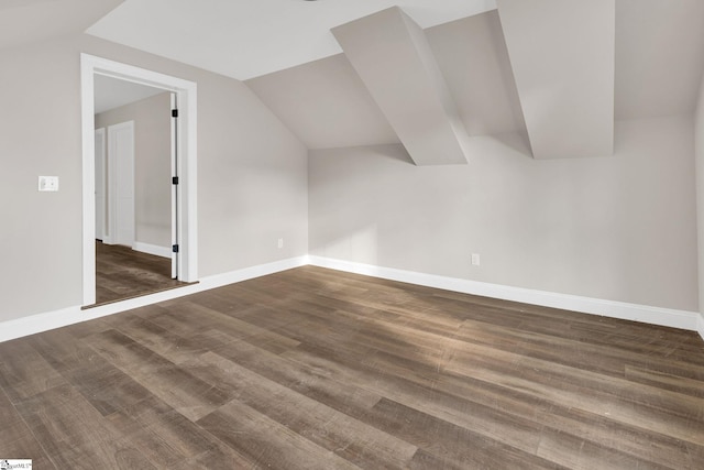 additional living space with lofted ceiling and dark hardwood / wood-style floors