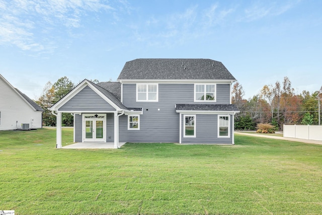 rear view of house featuring a patio area, french doors, and a lawn