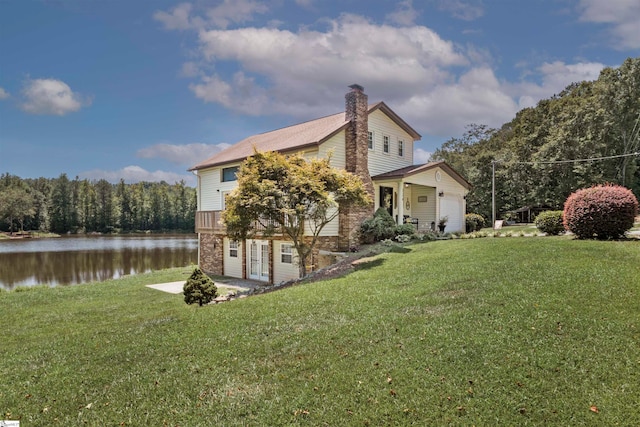 view of home's exterior featuring a water view and a lawn