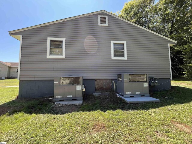 rear view of property with a yard