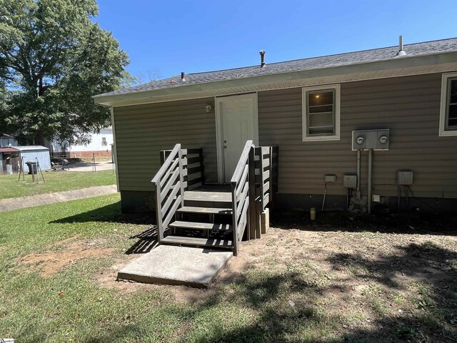 doorway to property with a yard