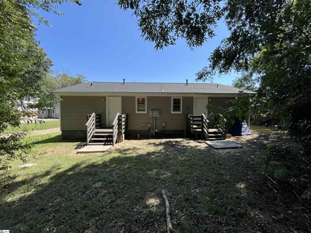 back of house with a lawn