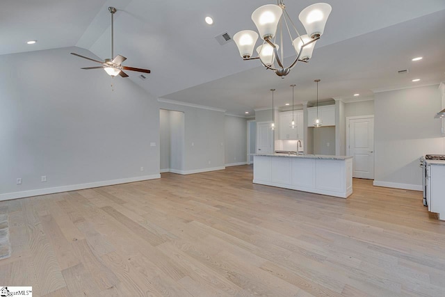 unfurnished living room featuring sink, vaulted ceiling, light hardwood / wood-style flooring, and ceiling fan with notable chandelier