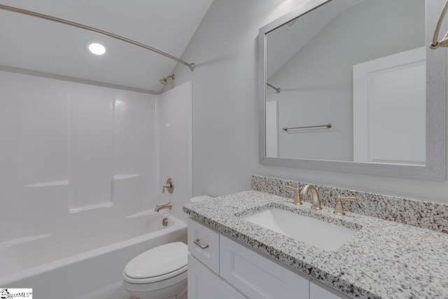 full bathroom featuring vaulted ceiling, bathing tub / shower combination, toilet, and vanity