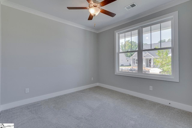 carpeted spare room featuring ceiling fan and ornamental molding