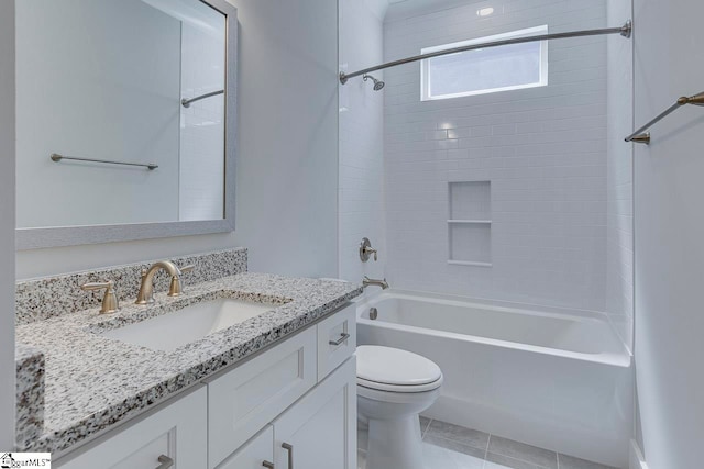 full bathroom featuring toilet, vanity, tiled shower / bath, and tile patterned floors