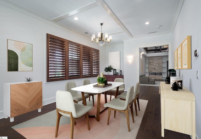 dining space with ornamental molding, a chandelier, and dark hardwood / wood-style floors