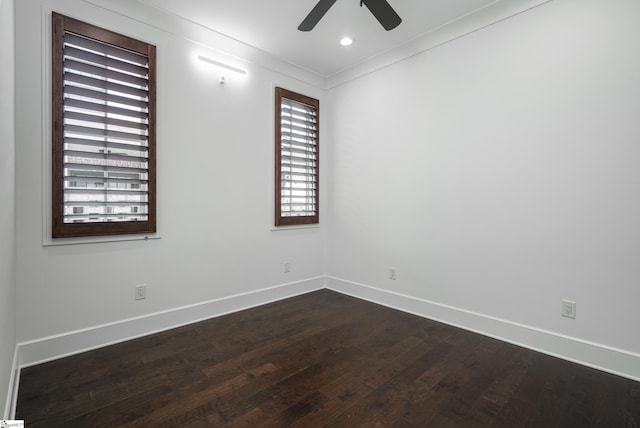 empty room featuring ceiling fan, ornamental molding, and dark hardwood / wood-style floors