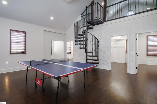 rec room featuring dark wood-type flooring and high vaulted ceiling