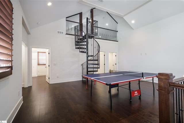 game room with high vaulted ceiling and dark hardwood / wood-style flooring