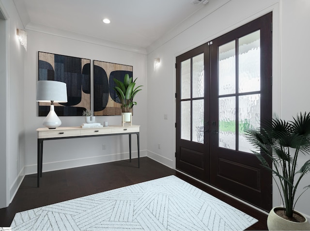 foyer entrance with french doors, ornamental molding, and dark hardwood / wood-style flooring