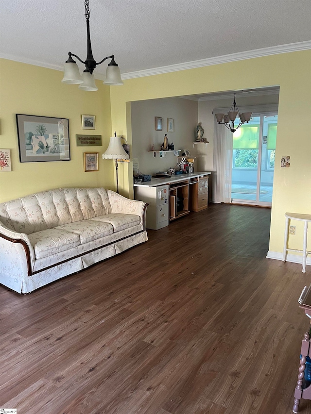 living room featuring dark hardwood / wood-style flooring, ornamental molding, wine cooler, a notable chandelier, and a textured ceiling