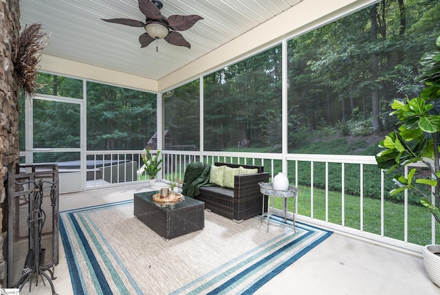 sunroom featuring ceiling fan