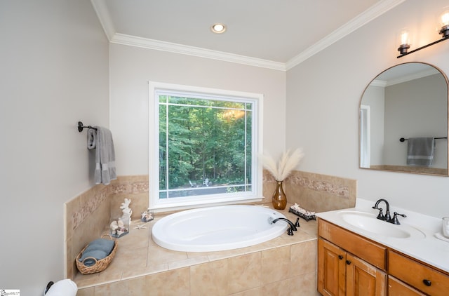 bathroom with tiled bath, ornamental molding, and vanity