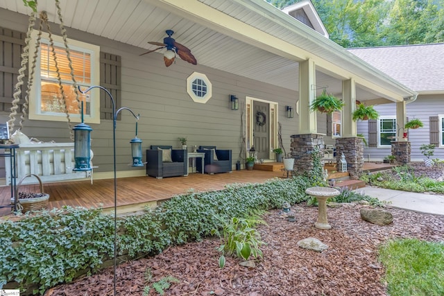 entrance to property with ceiling fan and a porch