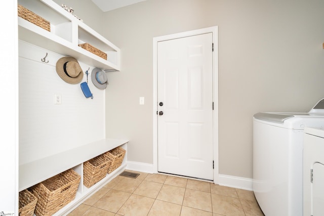 mudroom featuring washer and dryer and light tile patterned floors