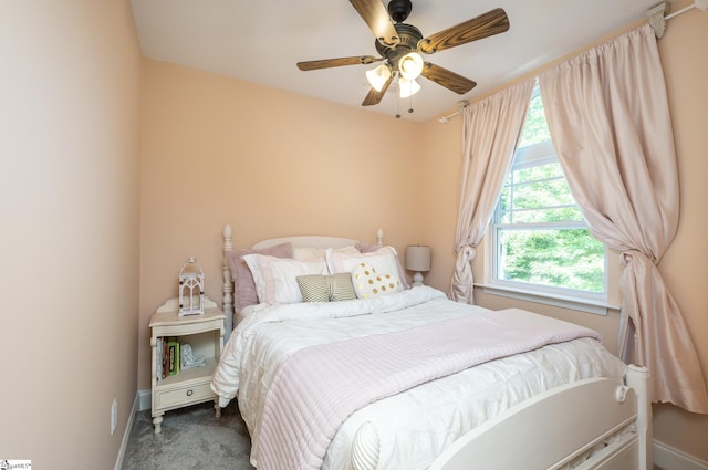 bedroom with ceiling fan and dark colored carpet