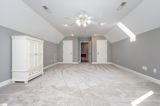 bonus room featuring ceiling fan, lofted ceiling, and light colored carpet