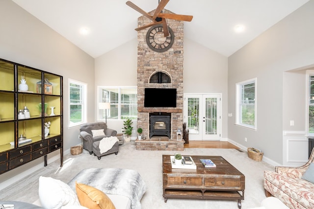 living room with ceiling fan, high vaulted ceiling, french doors, and a fireplace