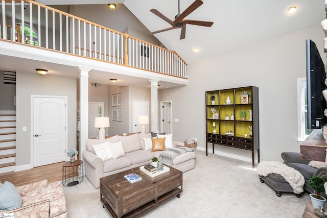 living room featuring ornate columns, high vaulted ceiling, light hardwood / wood-style flooring, and ceiling fan