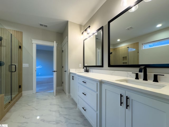 bathroom featuring marble finish floor, visible vents, and a sink