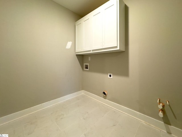 washroom featuring cabinet space, baseboards, hookup for a washing machine, marble finish floor, and hookup for an electric dryer