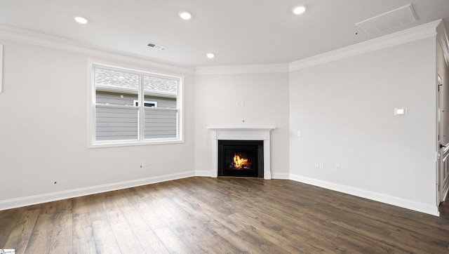 unfurnished living room featuring dark wood-style floors, ornamental molding, a lit fireplace, baseboards, and recessed lighting