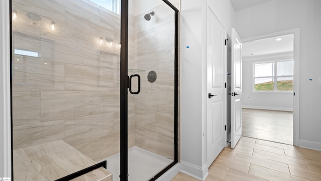 bathroom featuring baseboards and a shower stall