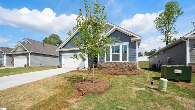 view of front facade with stone siding, a front yard, concrete driveway, and a garage