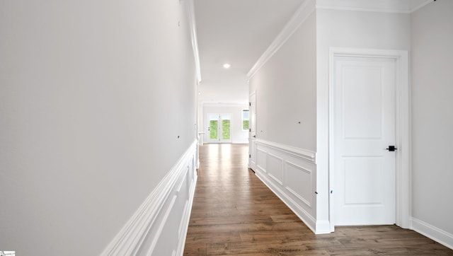 hallway featuring ornamental molding, wood finished floors, a wainscoted wall, a decorative wall, and recessed lighting