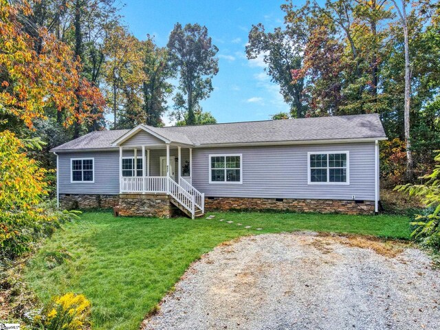 single story home featuring a front lawn and a porch