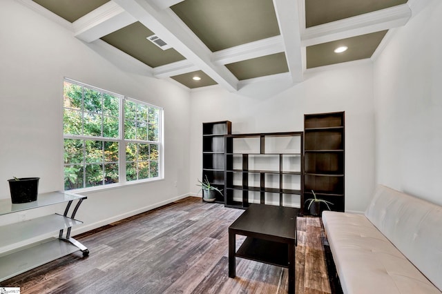 office space with coffered ceiling, visible vents, beamed ceiling, and wood finished floors