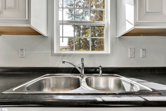 room details with dark countertops and a sink