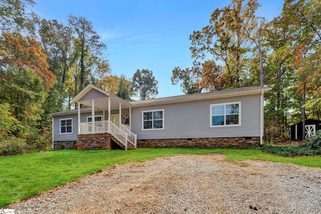 view of front of property featuring covered porch, crawl space, and a front yard