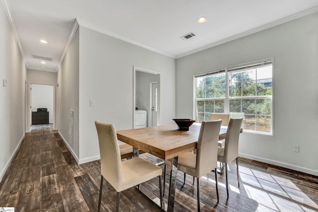 dining area featuring baseboards, visible vents, washer / clothes dryer, wood finished floors, and crown molding