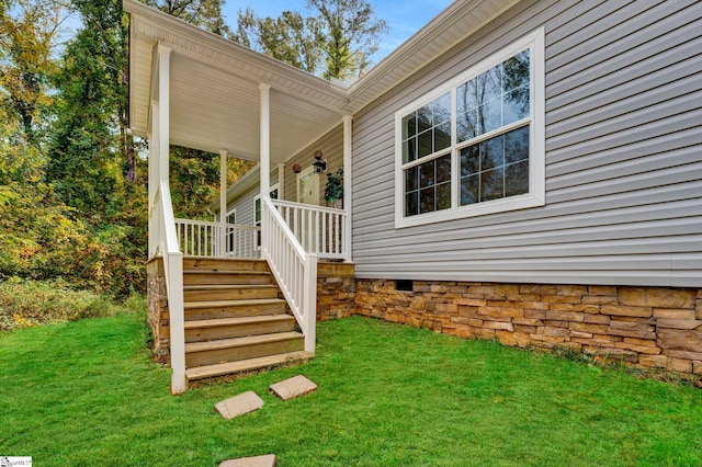 exterior space with crawl space, a porch, and a yard