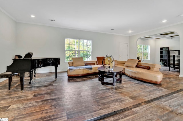 living area featuring plenty of natural light, visible vents, and wood finished floors