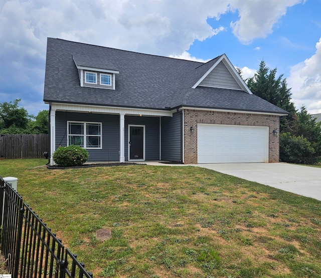 view of front of house with a front yard and a garage