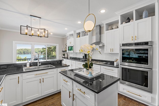 kitchen featuring wall chimney range hood, dark wood-type flooring, white cabinets, sink, and double oven