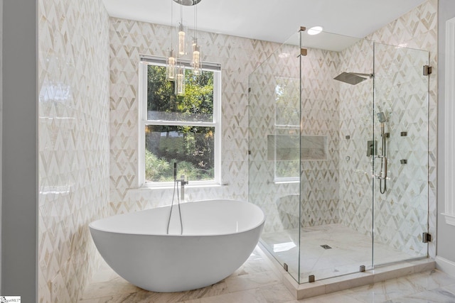 bathroom with tile walls, tile patterned flooring, plenty of natural light, and shower with separate bathtub