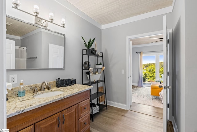 bathroom with hardwood / wood-style floors, wood ceiling, ornamental molding, and vanity