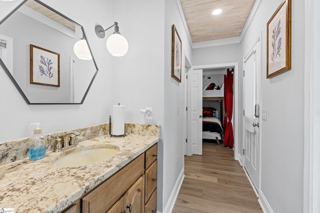 bathroom with vanity, hardwood / wood-style floors, and wooden ceiling