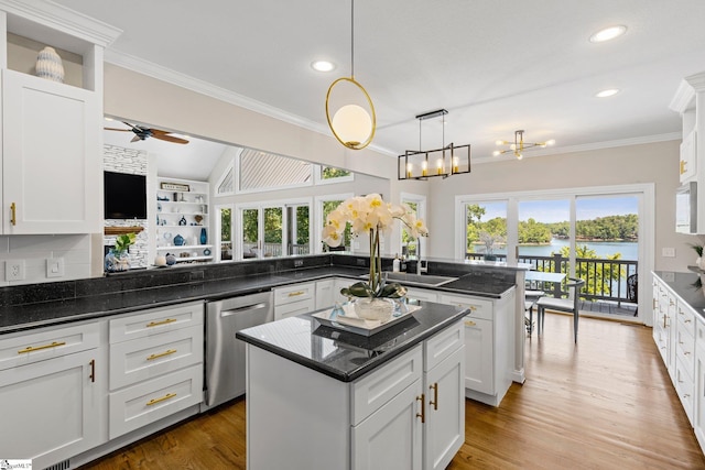 kitchen with hardwood / wood-style floors, ceiling fan with notable chandelier, a center island, and dishwasher