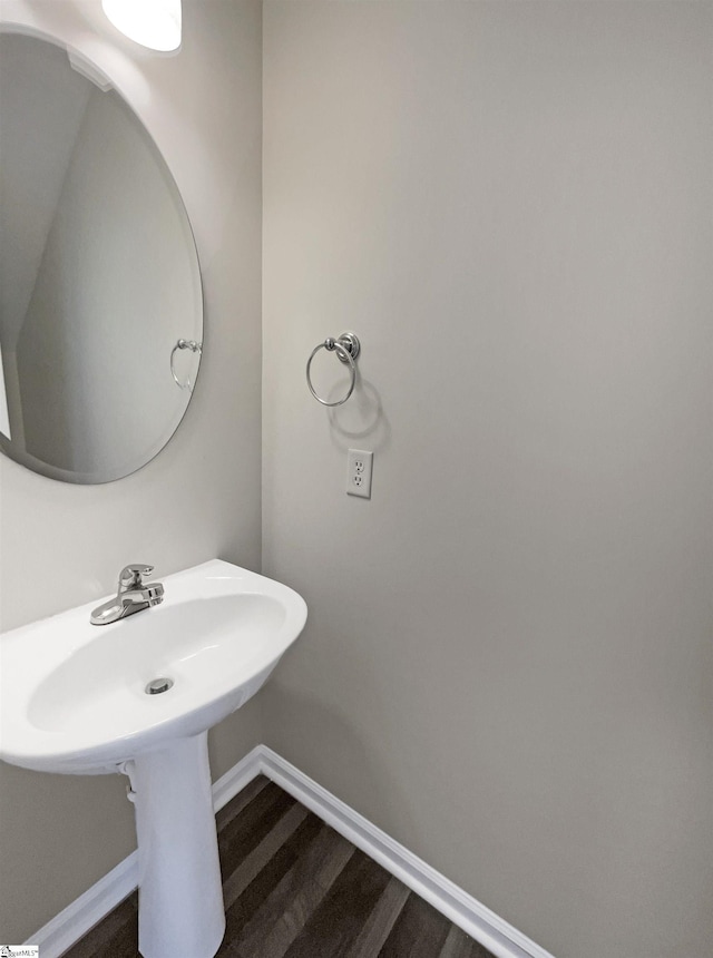 bathroom with baseboards and wood finished floors