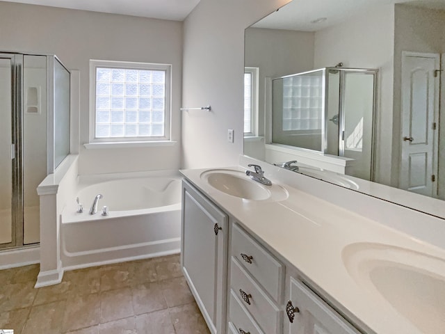 bathroom with double vanity, a sink, a bath, and a shower stall